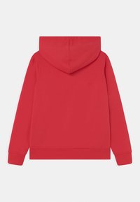 Felpa con cappuccio rossa, caratterizzata da un retro semplice con una consistenza morbida e polsini a costine. Il tessuto appare leggero e casual.