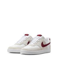 White sneakers with a maroon Nike swoosh, suede accents, perforated toe box, and white laces. Textured rubber sole with a raised edge.