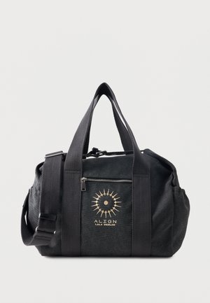 Borsa duffel nera con due manici, tracolla regolabile, tasca frontale con zip e logo a raggiera dorato con la scritta "ALIGN LALA BERLIN".