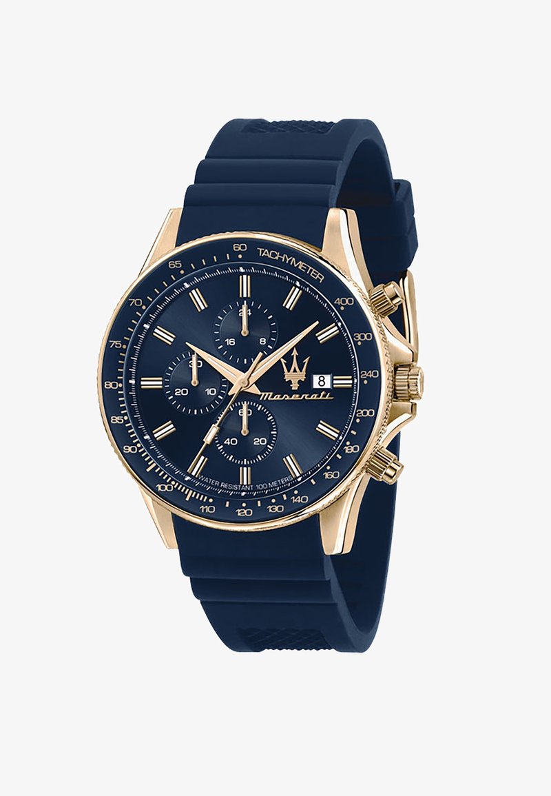 Orologio con cinturino in silicone blu e cassa in acciaio inox tono oro, quadrante blu scuro, tachimetro e sub-quadranti del cronografo. Presenta una finestra per la data.