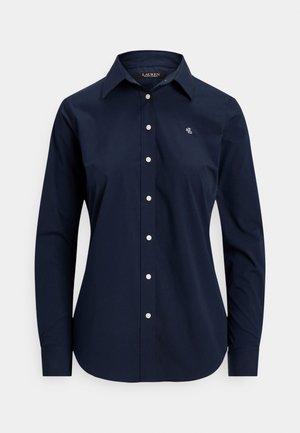 Navy blue long-sleeve shirt made of cotton, featuring a button-down front, collar, and white buttons; small embroidered logo on the chest.