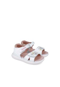 Sandali bianchi con motivi floreali, cinturini in velcro regolabili e accenti rosa. Foderatura interna morbida e dettagli a intaglio che migliorano la traspirabilità.