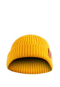 Yellow knit beanie with vertical ribbing, soft texture, and a brown leather logo patch on the side. Folded design at the cuff.