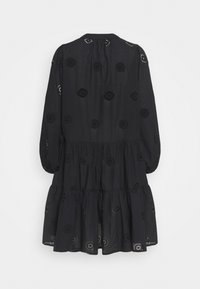 Black long-sleeve dress with tiered skirt and circular cut-out embroidery details, shown from the back on a plain background.