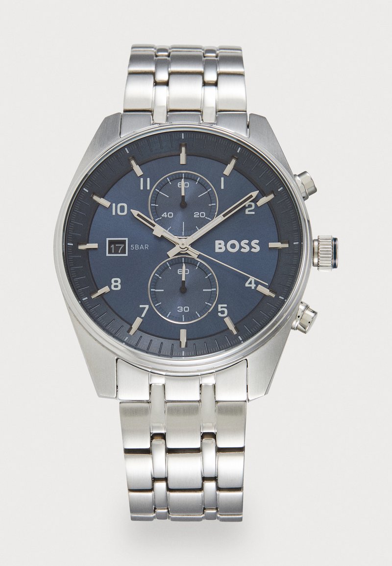Silver stainless steel watch with a navy blue dial, chronograph features, numeral markers, and linked bracelet. Water-resistant to 5 bar.