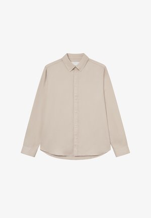 Light beige long-sleeve shirt with a button-down collar, front placket, and curved hem. Made from smooth fabric with a soft texture.