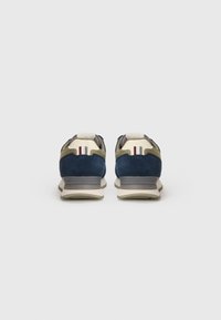 Blue and green suede sneakers with mesh accents, featuring a beige sole and red and white striping on the heel. Rear view displayed.