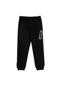 Schwarze Sweatpants mit elastischem Bund, Kordelzug, zwei Seitentaschen und einer Reißverschlusstasche am rechten Oberschenkel. Weicher Stoff mit glatter Textur.