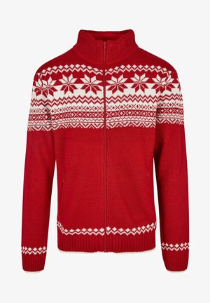 Červený svetr na zip s vysokým límcem. Bílý vzor sněhových vloček přes hruď a bílé detaily na rukávech a spodním lemu. Pletená textura.