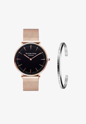 Sort urskive med rosegold metalnet rem; har enkle timemarkører og logo. Inkluderer et slankt sølvarmbånd med gravering.