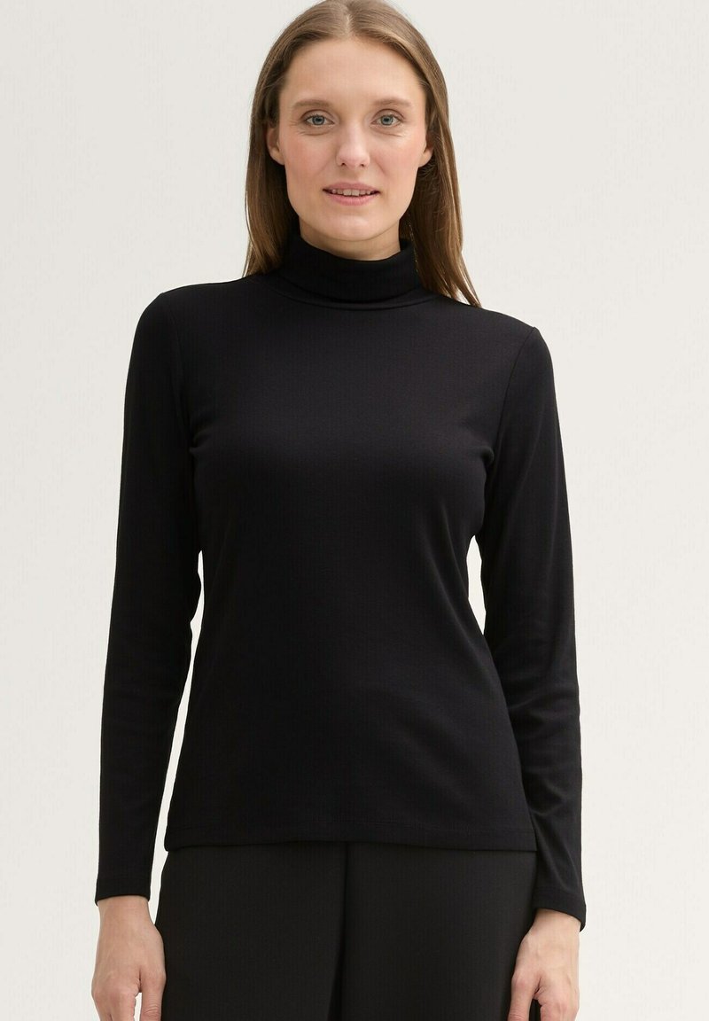 Schwarzes Langarm-Turtleneck-Shirt mit geribbelter Textur und schlanker Passform, gefertigt aus einem weichen Material, das sich gut für Lagen eignet.