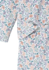 Floral patterned robe in soft fabric featuring pastel colors—orange, purple, teal—with gold accents and loose sleeves. Smooth texture.