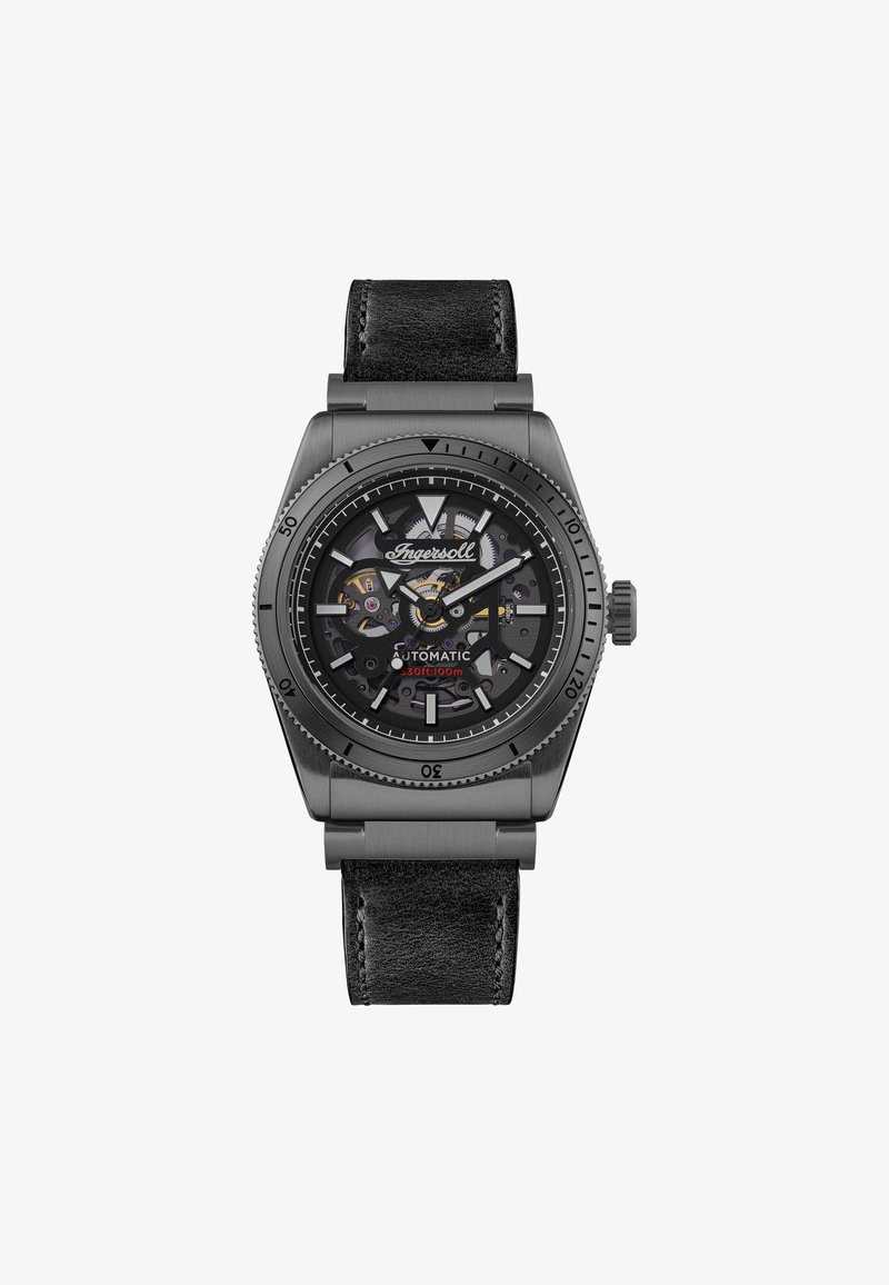Automatische Armbanduhr mit schwarzem Lederarmband. Sechseckiges Metallgehäuse in mattem Grau, transparentes Ziffernblatt, das komplexe Zahnräder und Markierungen zeigt.