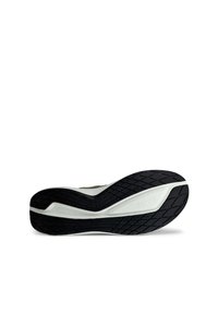 Shoe sole featuring a black rubber tread pattern, curved white midsole, and subtle branding. Designed for traction and comfort.