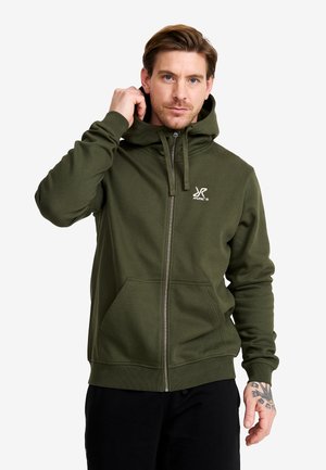 Dark green zip-up hoodie with a kangaroo pocket, adjustable hood, and white logo on the left chest. Smooth fabric with a relaxed fit.