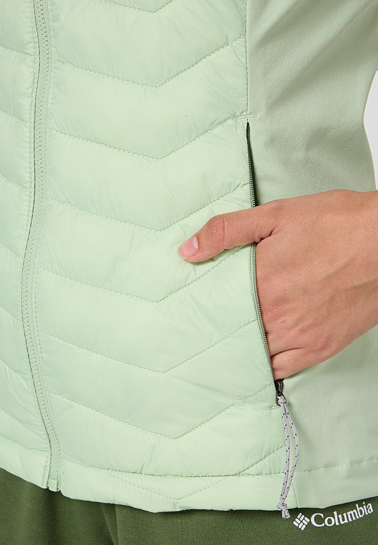 Gilet isolé vert clair avec un motif en chevrons, tissu lisse, poche zippée latérale avec un onglet à cordon.