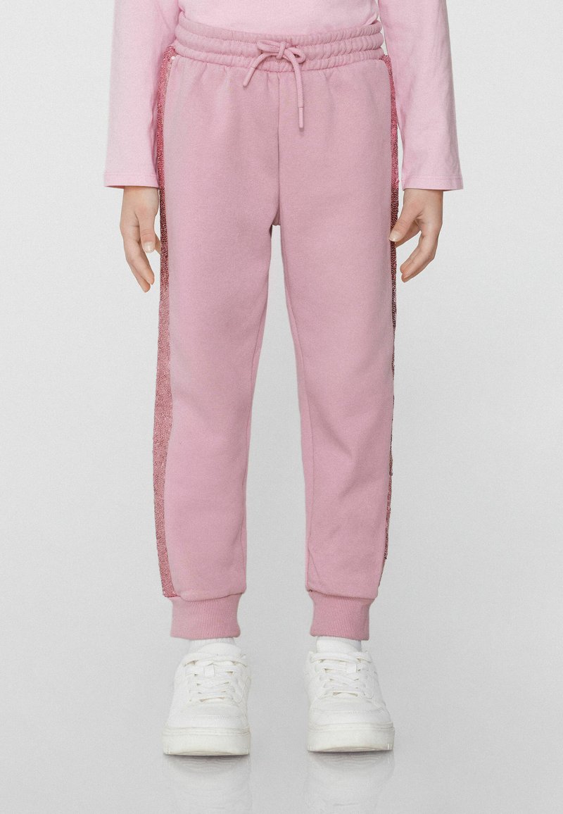 Rosa Jogginghose mit Kordelzugbund, verziert mit glitzernden Seitenstreifen und gerippten Knöcheln. Hergestellt aus weichem, strukturiertem Stoff.