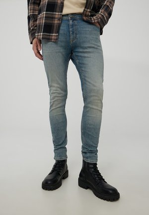 CON EFFETTO SBIADITO - Jeans slim fit - blu denim medio