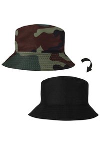 Reversible bucket hat with one side camouflage pattern in green, brown, and black, and the other side solid black.