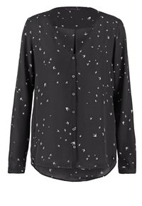 Blouse noire à manches longues en tissu léger avec un col en V et une fermeture à boutons, décorée d'un motif d'oiseaux blancs sur l'ensemble.