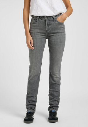 Jeans in denim grigio con una vestibilità slim, vita alta e design a cinque tasche. Texture liscia con un leggero sbiadimento sulle ginocchia. Abbinati a sneakers nere.