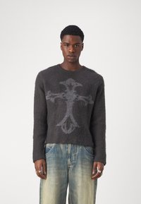 Dark gray wool pullover sweater with a soft texture and a lighter gray graphic design resembling a cross on the front.