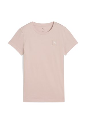 T-shirt in cotone rosa chiaro con maniche corte, scollatura rotonda e una piccola etichetta con logo bianco sul lato sinistro del petto. Texture morbida.