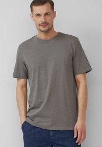 Grijs shirt met korte mouwen van een zachte, gestructureerde stof. Beschikt over een ronde hals en een klein, lichtblauw logo op de borst.