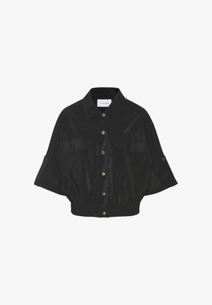 Black cropped jacket with wide sleeves, snap buttons down front, two chest pockets, and elastic waistband.