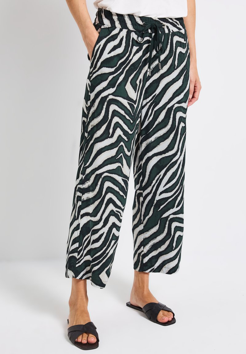 Grüne und weiße Zebra-Muster weit geschnittene Hosen, aus leichten Stoff mit elastischem Bund und Kordelzug. Mit Seitentaschen.