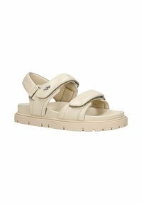 Sandali in pelle beige con cinturini regolabili, soletta morbida e suola in gomma testurizzata con motivo per una maggiore aderenza.