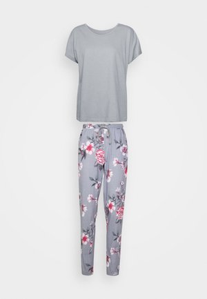 Gray short-sleeve top paired with floral-patterned gray joggers featuring a drawstring waistband. Soft cotton material.