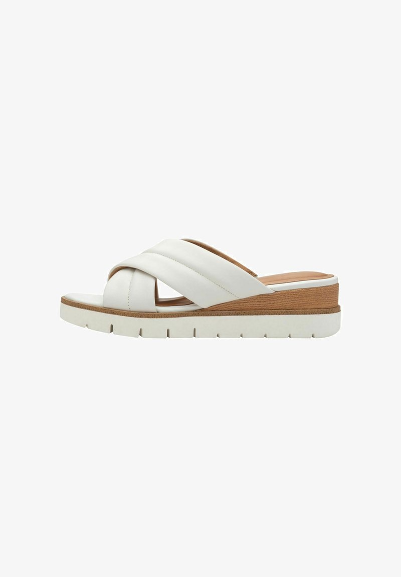 White leather slide sandal with crisscross straps, lightweight platform sole, wooden accent, and a textured rubber outsole.