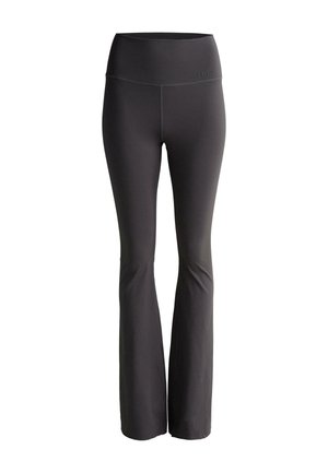 Pantaloni yoga grigi a zampa d'elefante con vita alta. Realizzati in un tessuto liscio ed elastico, presentano un design minimalista e nessun motivo visibile.