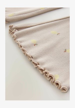 Tessuto beige chiaro a righe con una texture a coste, caratterizzato da piccoli motivi di palloncini gialli e un orlo arricciato lungo il bordo.