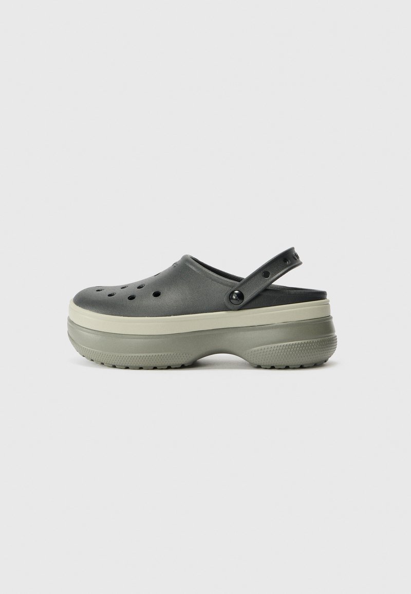 Black clogs with a raised sole and grey accents, featuring holes for ventilation, a back strap, and a textured rubber outsole.