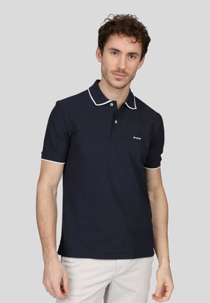 Polo marine en coton, avec un col classique à bord blanc, des manches courtes et un petit logo sur la poitrine gauche.