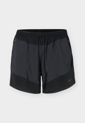 Pantaloncini da corsa neri Nike con tasche laterali con zip e vita con coulisse, con piccolo logo Nike Swoosh sulla gamba sinistra.