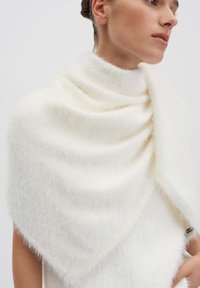 Sciarpa bianca e soffice che si drappeggia elegantemente attorno alle spalle, con un tessuto morbido e testurizzato e una finitura liscia, dalla forma triangolare.