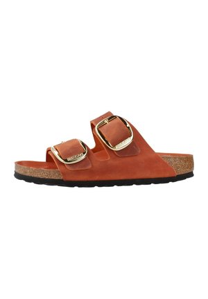 Brown leather slide sandals with two adjustable gold buckles, cork footbed, and a textured black rubber sole.