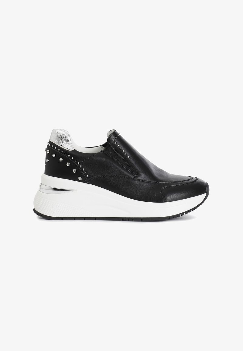 Black leather slip-on sneaker with silver accent at heel, studded detailing along side, and a white wedge sole. Textured rubber outsole.