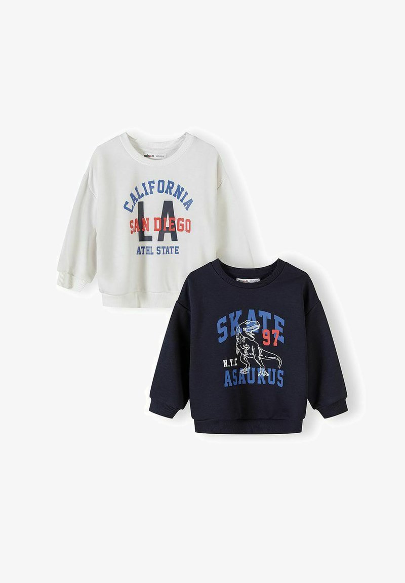 Deux sweat-shirts pour enfants : blanc avec le texte "California LA San Diego Athl State", marine avec "Skate 97 N.Y.C Asaurus" et un motif de dinosaure.