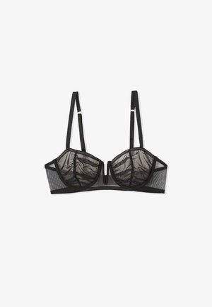 Soutien-gorge en mesh noir avec des bonnets transparents, des coutures structurées et un arc-en-ciel ; dispose de bretelles réglables et d'une fermeture à crochets dans le dos.