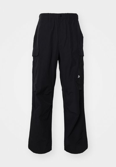 Svart cargobukser med elastisk linning, multiple sidelommer og avslappet passform. Laget av lett materiale.