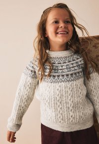 Light blue knitted sweater featuring a cable pattern and colorwork yoke in shades of gray and brown. Ribbed cuffs and hem.