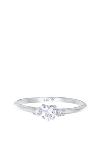 Silver ring with a heart-shaped clear gemstone at the center, flanked by two smaller clear stones, featuring a smooth band design.