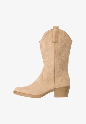 Stivale da cowboy Western in camoscio beige fino al polpaccio, con motivi decorativi cuciti e tacco basso a blocco, mostrato dal lato esterno.