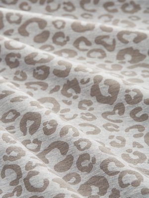 Luipaardprint stof in lichtgrijs met taupekleurige vlekken, voorzien van een zachte textuur en subtiel geribbelde structuur, gevouwen om diepte te tonen.