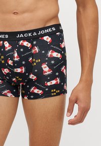 Schwarze Boxer-Briefs mit einem festlichen Muster von Santa Claus und Schneeflocken, mit dem "JACK & JONES" Logo auf dem elastischen Bund.