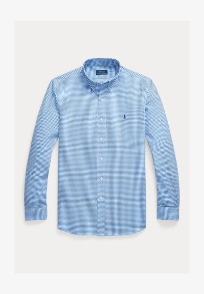 Helehallikasvalge ruuduline pikkade varrukatega triiksärk, nööpidega kaeluse ja väikese tikitud Polo logoga rinnal.